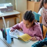 Students in a classroom with smartphones put away during a lesson
