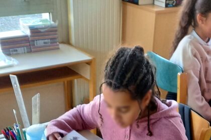 Students in a classroom with smartphones put away during a lesson