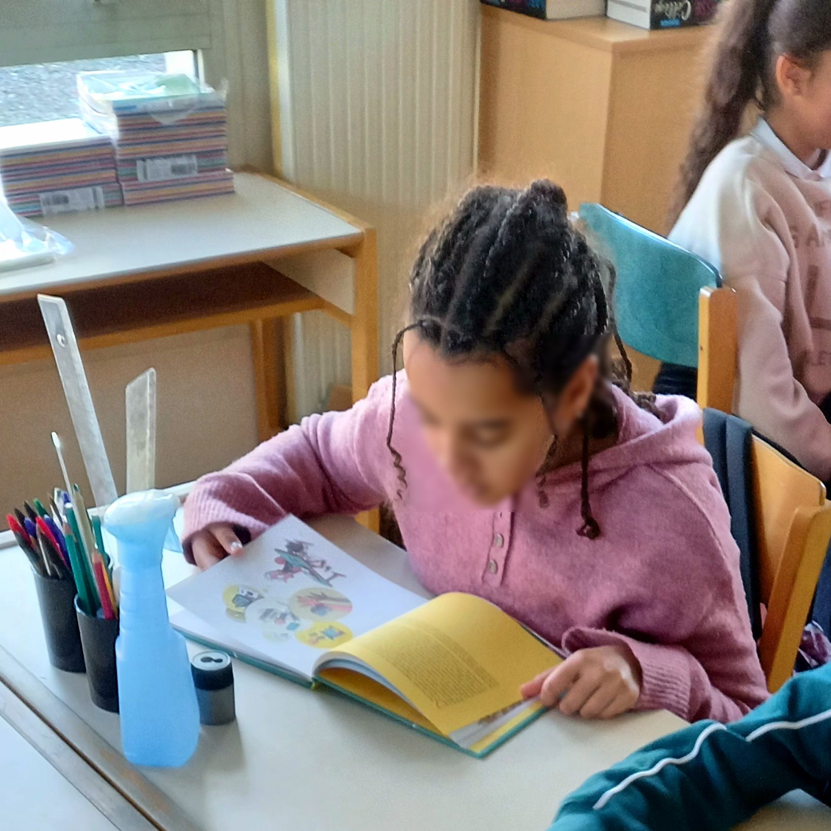 Students in a classroom with smartphones put away during a lesson